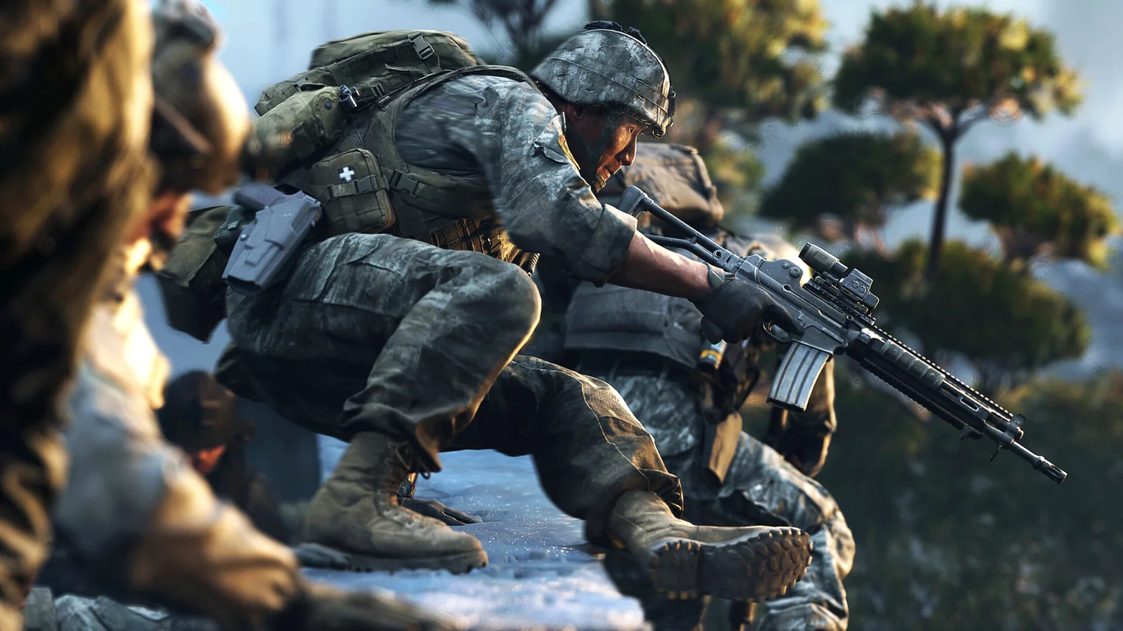 A squad advancing across broken rocky ground